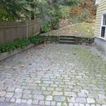 Antique cobblestone (Belgian Block) parking area with granite curbing retaining wall