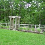 Vegetable garden enclosure - rustic fence with arbor