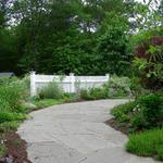 Broken bluestone walk creates informal path to back yard sunroom