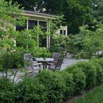 Mature plantings surround this cozy eating area.