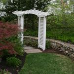 Fieldstone wall adds continuity between the stepping stone path and the lawn beyond.