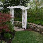 Lilac colored stepping stone path with Arbor and mixed fieldstone retaining wall