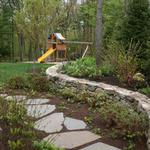 Fieldstone mix stone wall with broken bluestone path