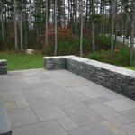 Van Tassel granite sitting and retaining wall with multiple pattern lilac colored bluestone patio