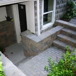 Concrete block retaining wall and steps and concrete paver landing to basement access